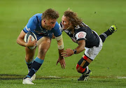 David Kriel of the Blue Bulls tries to evade a tackle from Werner Kok of the Sharks in the Currie Cup final at Loftus Versfeld in Pretoria on September 11 2021.