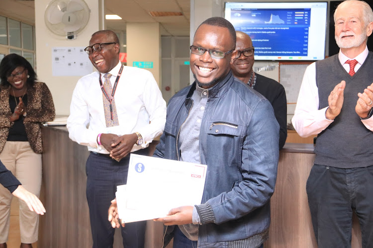 Designer of the Quarter Hillary Bett basks in applause from managers (L-R in the back) Jemima Ngode (HR), Group CEO Patrick Quarcoo, business editor Francis Openda and director of convergence William Pike