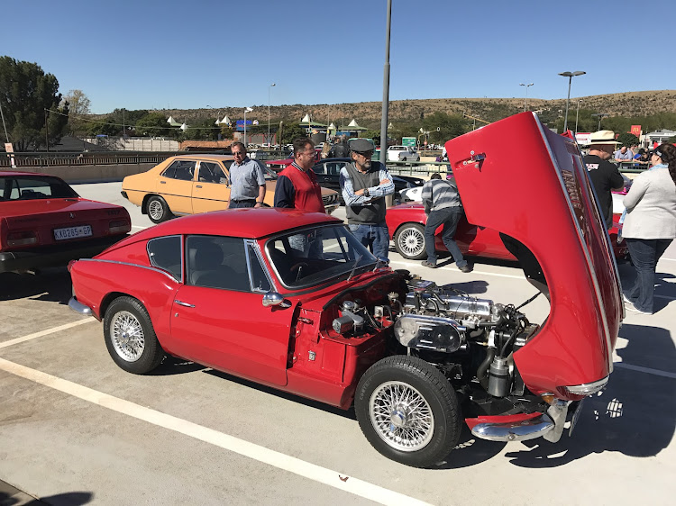 An eighties Mitsubishi Colt Gallant mixes with rare classics such as the red Triumph TR6.