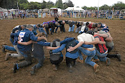 A prayer circle  before the bull ride.