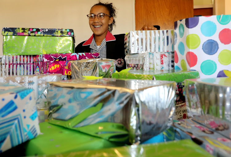 Jae-Lynn Helmey, a grade 6 pupil at Santor Primary School, with some of the gift boxes filled by pupils and other do-gooders