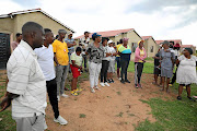 Daveyton residents outside the RDP houses they were evicted from.