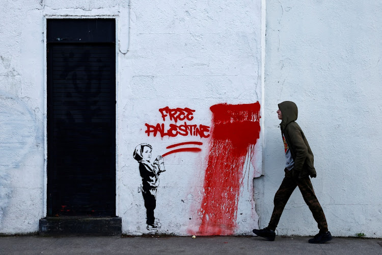 A man walks past graffiti reading 'Free Palestine', amid the ongoing conflict between Israel and the Palestinian Islamist group Hamas, in Dublin, Ireland. File photo: CLODAGH KILCOYNE/REUTERS
