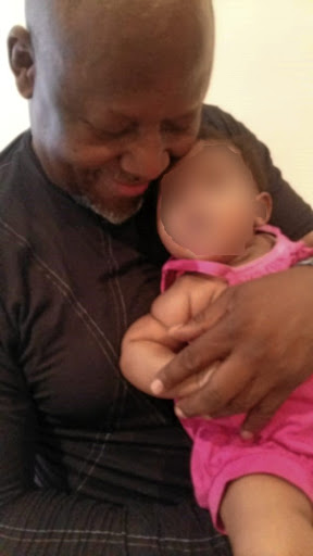 Mike 'Sporo' Mangena cuddling the baby whose paternity he is now disputing