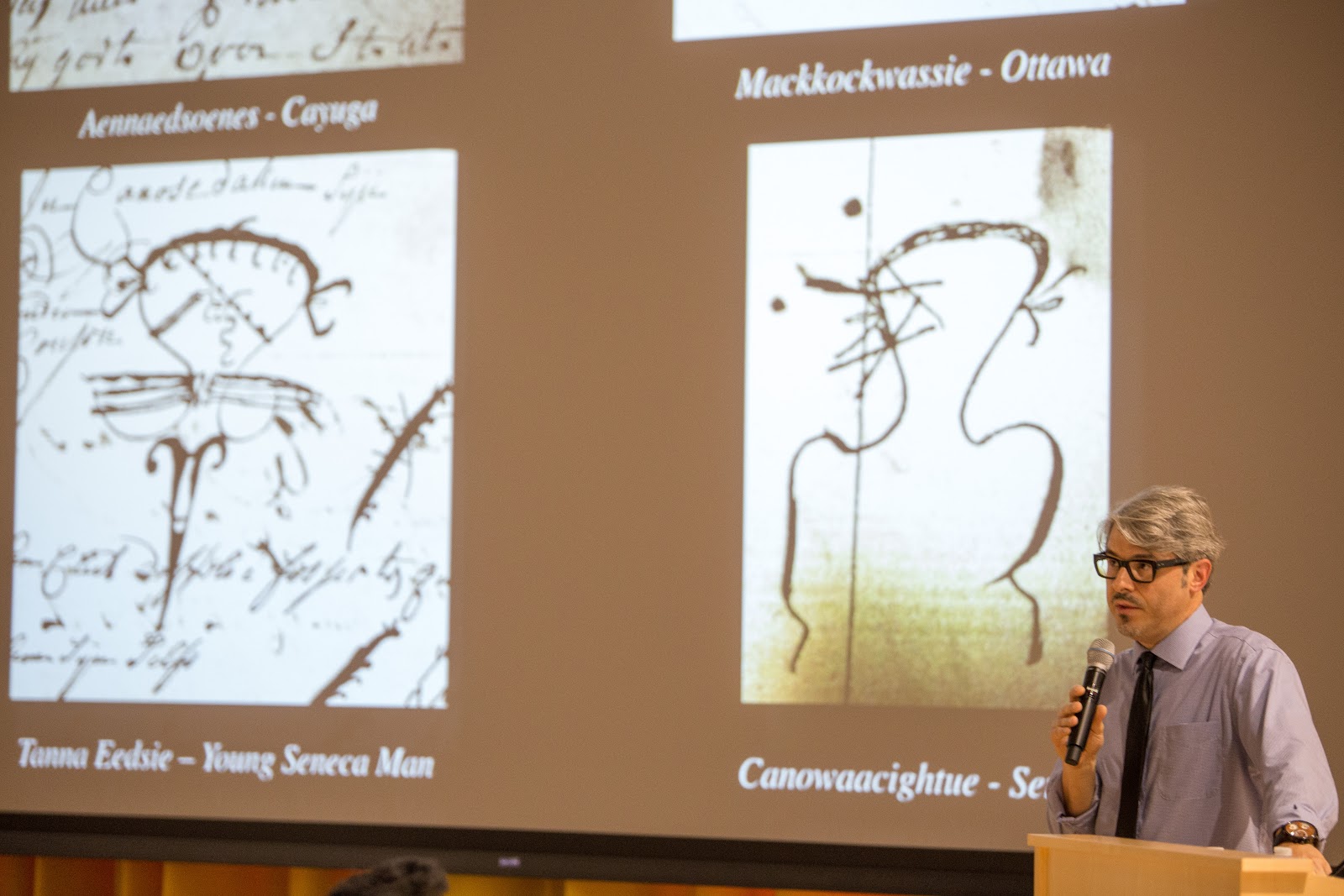 Lars Krutak in front of a slide depicting tattoos of men from the Seneca. Photo: Alex Hamer