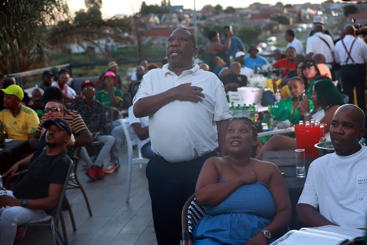 Fans watching Bafana Bafana and Nigeria at Disoufeng Pub Meadowlands Zone 10, Soweto.