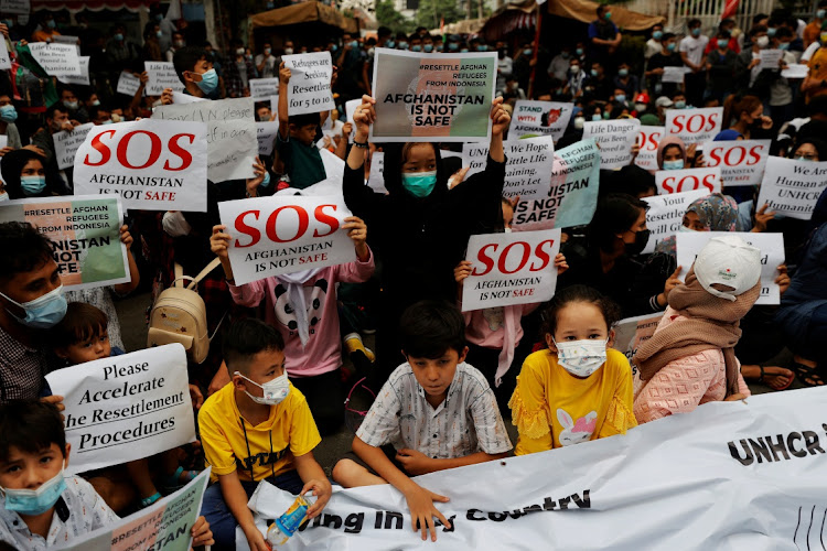 Afghan refugees ask for justice and resettlement during a rally outside the UN Refugee Agency UNHCR's office in Jakarta, Indonesia. Picture: REUTERS/Willy Kurniawan