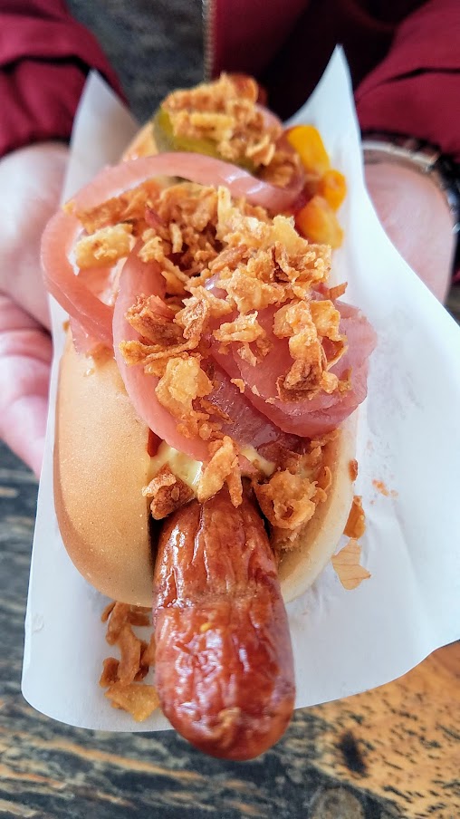 The food market of Reffen, a Danish hot dog made with organic sausage and in my case also had cheese inside, topped with crunchy fried onions, raw onions, pickles, and dressed with mustard, ketchup and remoulade..