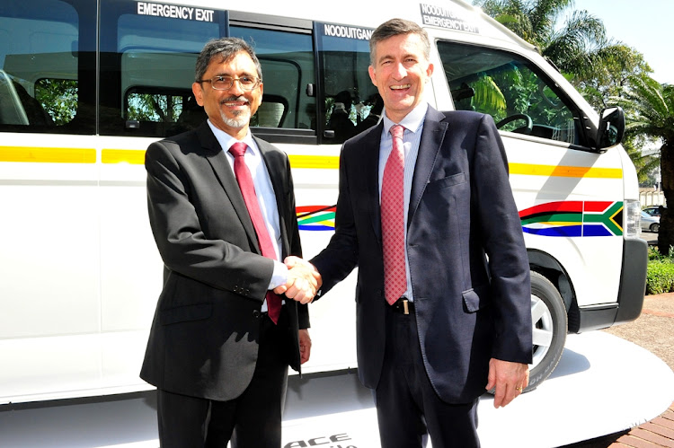 Minister of trade, industry and competition Ebrahim Patel shakes hands with Andrew Kirby, president and CEO of Toyota SA.