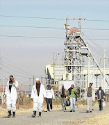 Miners like these at Rustenburg's Amplats mine are struggling to live off what remains of their pay after employers have deducted debt repayments