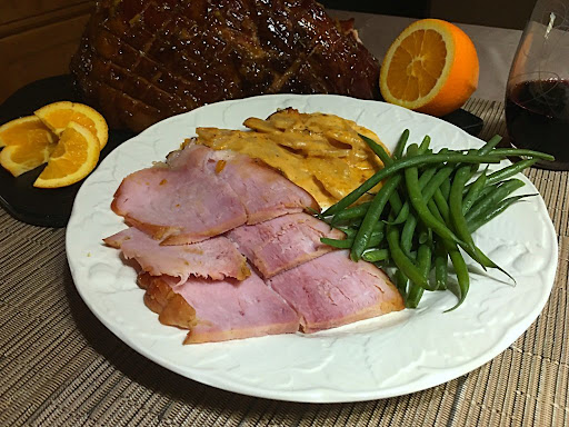 Slices of Grand Curacao glazed cooked ham along with steamed green beans and scalloped potatoes.