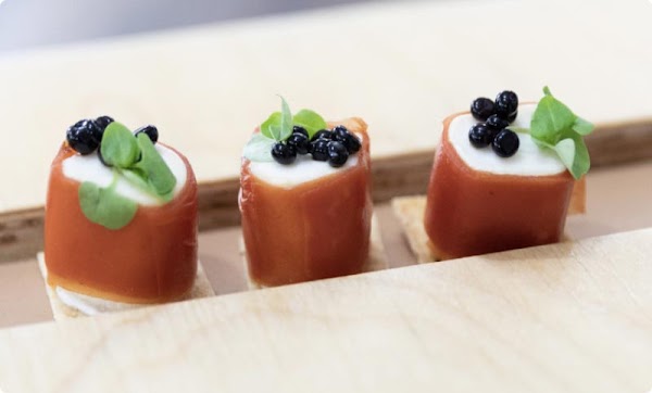 A closeup photo of three vegan-friendly finger food rolls.