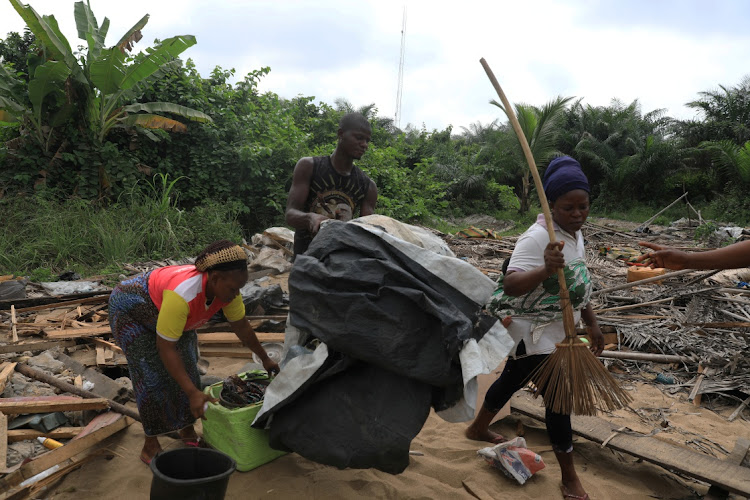 Displaced inhabitants of the Okun Glass community pick up their belongings amidst the rubble at the site of demolition in Lagos, Nigeria, in this January 16 2020 file photo. Picture: REUTERS/TEMILADE ADELAJA