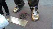 EFF student leader places rats at Mandela’s statue.