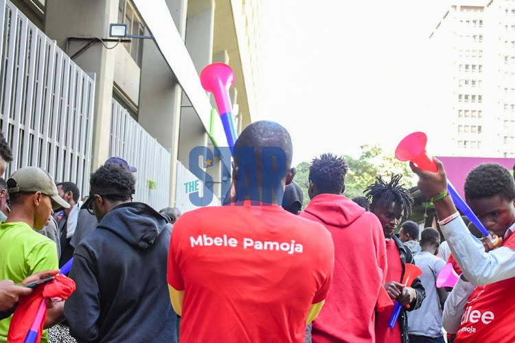 A Jubilee fan blow a vuvuzela at Nairobi CBD during the Azimio NDC at KICC on March 12, 2022.