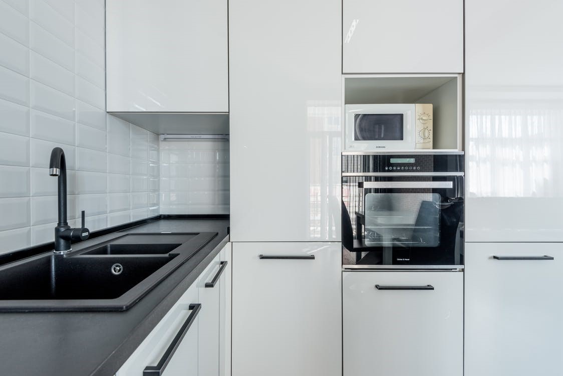 Free Modern white kitchen with black sink and oven Stock Photo