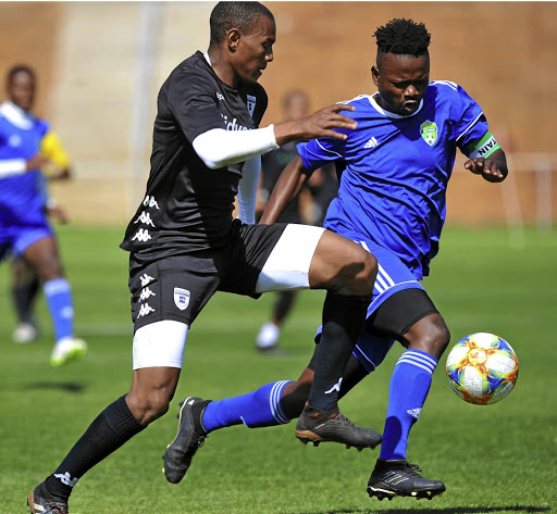 Prince Nxumalo of Wits challenged by Khanyiso Ginxa of Keyona during a friendly match.