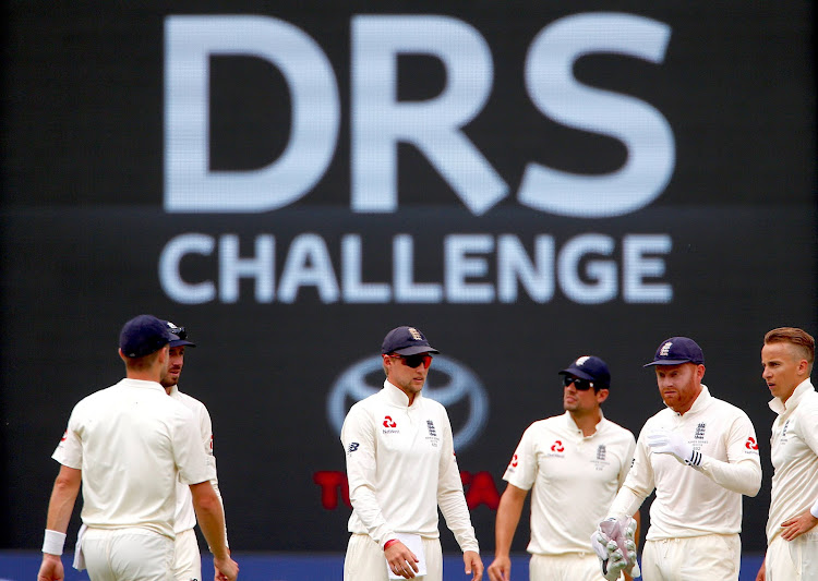 England's captain Joe Root talks with team mates after he called for a DRS challenge during the fourth day of the fourth Ashes cricket test match.