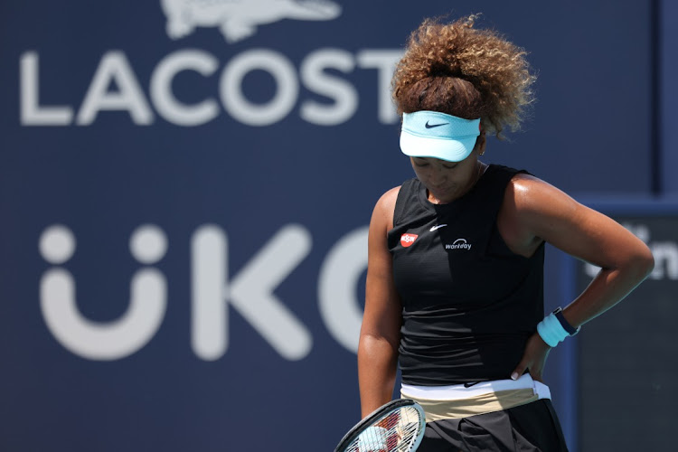 Naomi Osaka of Japan reacts after missing a shot against Maria Sakkari of Greece in a women's singles quarterfinal in the Miami Open at Hard Rock Stadium on March 31, 2021