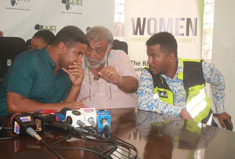 Haki Africa's Hussein Khalid [L] and Mathias Shipeta [R] consult with a colleague at their office in Mombasa yesterday