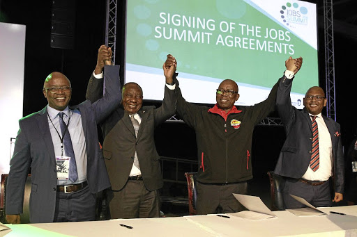 Sipho Pityana, President Cyril Ramaphosa, Bheki Ntshalintshali and Thulani Tshefuta celebrate after signing a framework agreement to create 275 000 jobs.