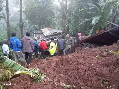 People inspect a house that has been damaged by landslides due to the ongoing heavy rains at Kamuchiri village in Mai Mahiu, Nakuru County on Aril 29. 2024.