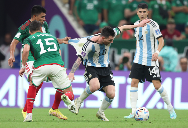 Lionel Messi (2nd R) of Argentina in action during a World Cup Group C match against Mexico at the Lusail Stadium on November 26