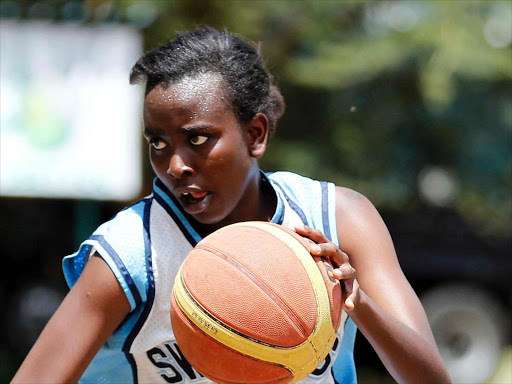 Sarah Wanjiku (R) of Strathmore during their Tom wanyama Open Basketball tournament at the Nairobi Railway Club on October 13, 2013.