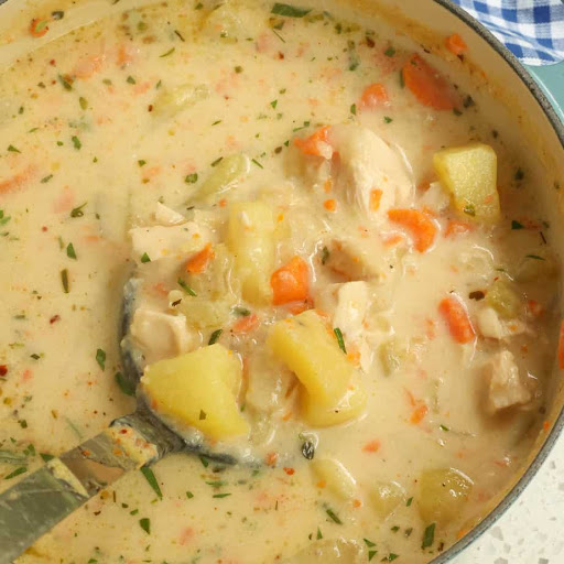 This Creamy Chicken Potato Soup recipe combines onions, carrots, celery, potatoes, and cooked rotisserie chicken in a creamy cheddar broth seasoned with thyme and rosemary.

