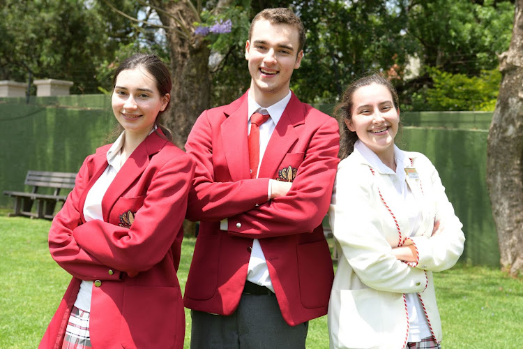 Redhill's Buckland triplets who between them achieved 24 distinctions, Anna, Ivan and Jessica.