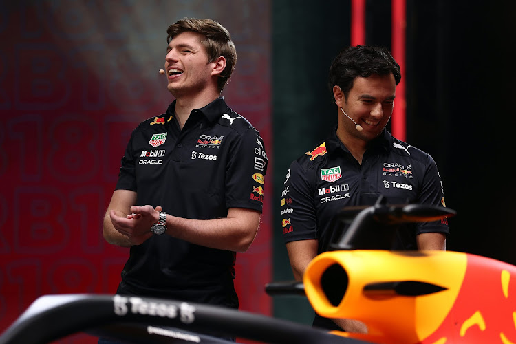 Max Verstappen and Sergio Perez talk on stage during the Red Bull Racing RB18 launch at Red Bull Racing Factory on January 26 2022 in Milton Keynes, England.