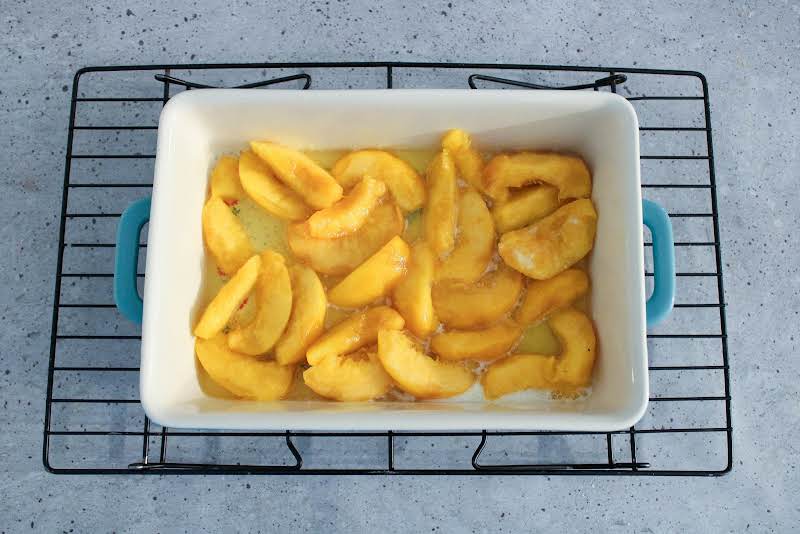 Fruit Added To The Melted Butter In The Baking Dish.