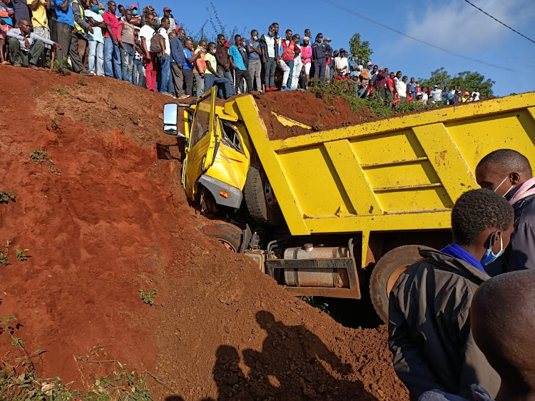 Onlookers jam the scene where a construction lorry rammed into a road embankment in Embu town, killing the driver.