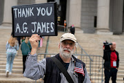 Anti-Trump demonstrators gather outside of the New York County Supreme Court in New York City, US, April 25, 2022. 