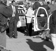 CRIME VICTIM: The body of Sergeant Moeketsi Lekojane is covered with a blanket after he was shot dead in Zola, Soweto, yesterday. Pic. Lucky Nxumalo. 29/08/07. © Sowetan.