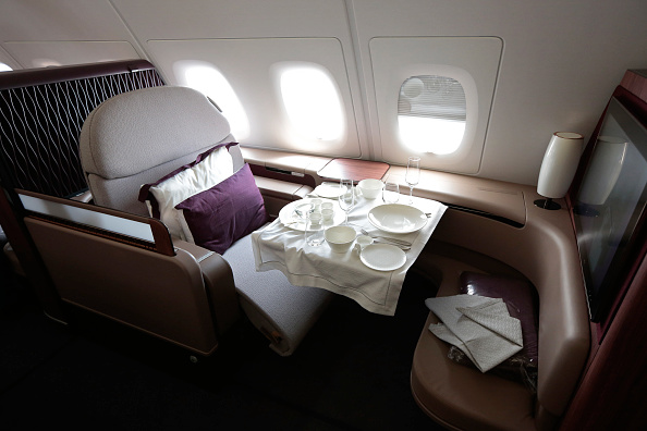 A dining set sits on the table of a First Class passenger booth inside an Airbus SAS A380 aircraft, operated by Qatar Airways.