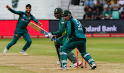 Andile Phehlukwayo of South Africa watches the ball go past out of reach of Pakistan wicketkeeper/batsman and captain Sarfraz Ahmed (c) during the International One Day Series game at Kingsmead Stadium in Durban on January 22 2019.