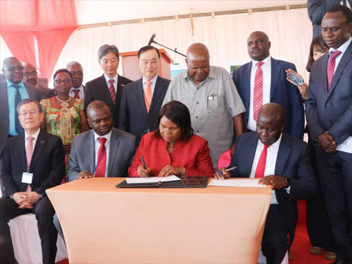 PS Colletta Suda and Konza Technopolis Development Authority CEO John Tanui sign the certifi cate of commencement on Tuesday /ANDREW MBUVA