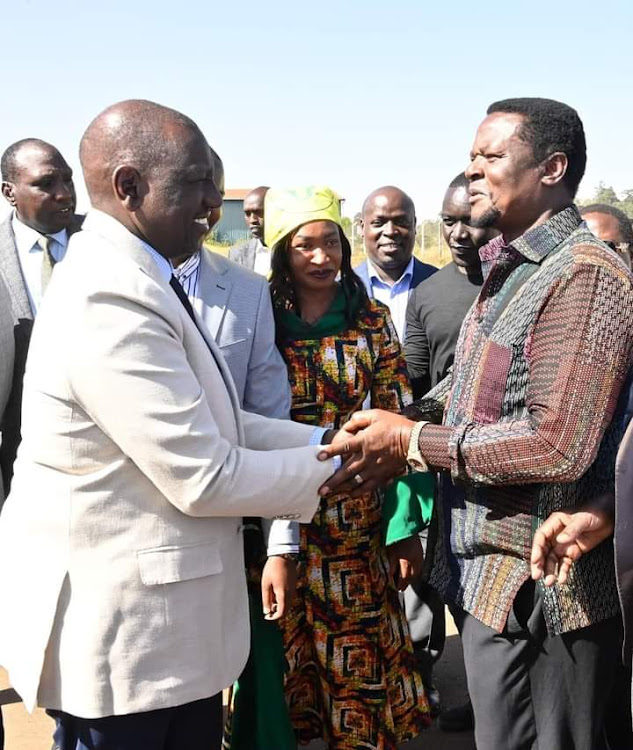 President William Ruto shake hands with Sirisia MP John Waluke.