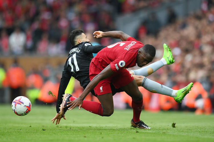 Ibrahima Konate of Liverpool is challenged by Gabriel Martinelli of Arsenal in the Premier League match at Anfield in Liverpool on April 9 2023.