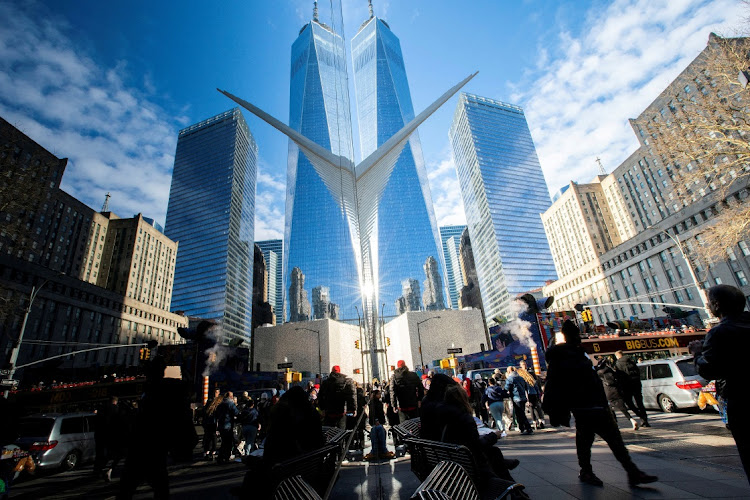 People walk near the New York Stock Exchange in New York, the US, December 29 2023. Picture: REUTERS/EDUARDO MUNOZ