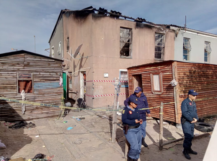 Police outside suspect's home in Mitchells Plain where Stacey Adams' body was discovered.