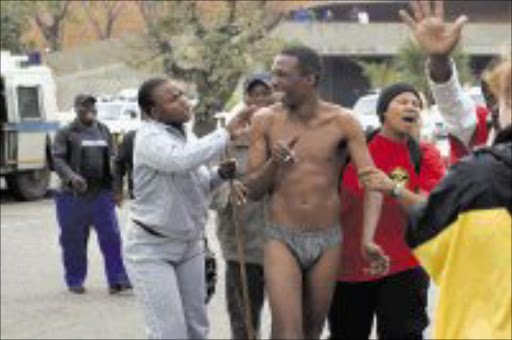 NO DIGNITY: Ekurhuleni Metro Council worker Wessels Lesenyelo stripped during a strike in Germiston yesterday. Pic. Antonio Muchave. 27/05/08. © Sowetan.