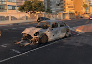 Peter Wagenaar's burnt-out Mini Cooper in Beach Road, Mouille Point, on May 6 2020.