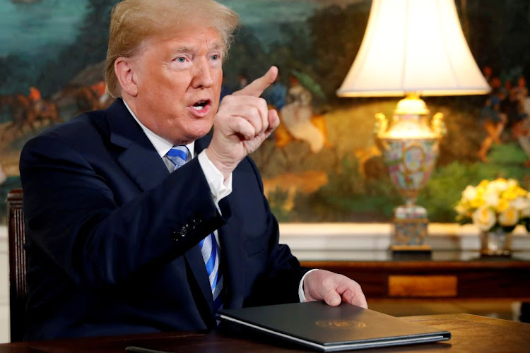 US President Donald Trump speaks to reporters after signing a proclamation declaring his intention to withdraw from the Iran nuclear agreement at the White House in Washington on May 8 2018.