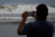 A man photographs the waves before the arrival of the Hurricane Maria in Guayama, Puerto Rico September 19, 2017. 