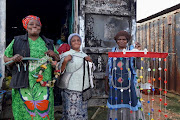 From left, Nosizwe Dingaan, Nosipho Mayinje and Thenjiwe Jacobs with  items made from recycled materials.