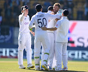 James Anderson celebrates with teammates after dismissing Kuldeep Yadav of India to claim his 700th test wicket in Dharamsala on Saturday. 