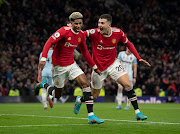 Marcus Rashford of Manchester United celebrates scoring with teammate Diogo Dalot in the Premier League match against West Ham United at Old Trafford  in Manchester on January 22 2022.