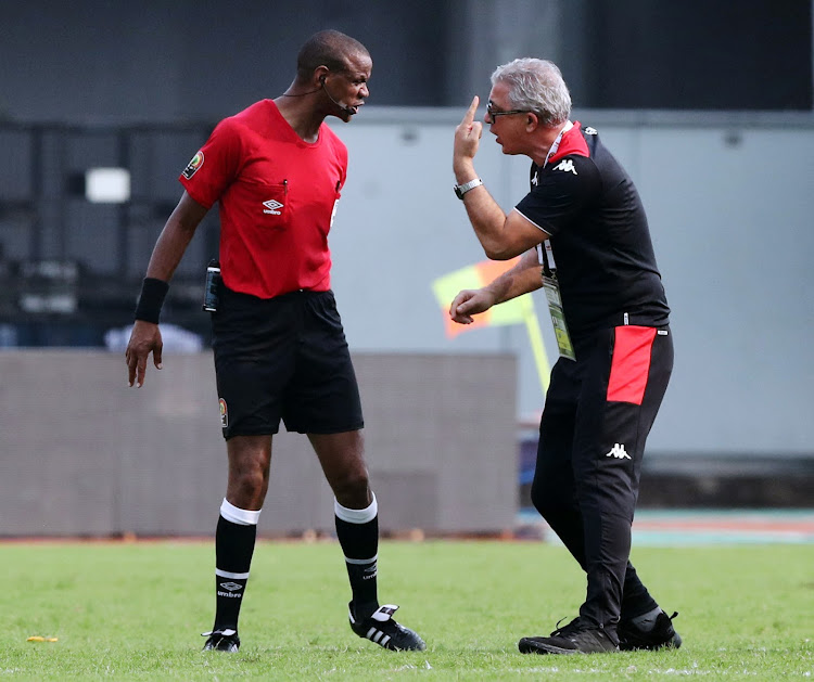 Tunisia coach Mondher Kebaier remonstrates with the referee Janny Sikazwe after the match